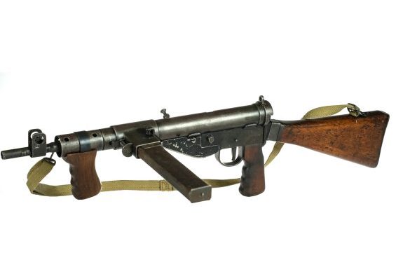 Vintage submachine gun with wooden stock.