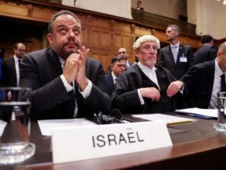 Officials seated at courtroom table labeled Israel.