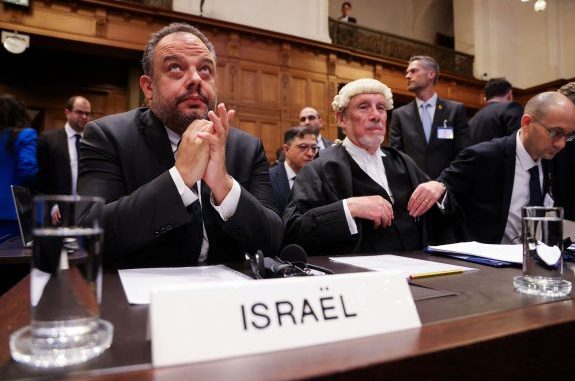 Officials seated at courtroom table labeled Israel.