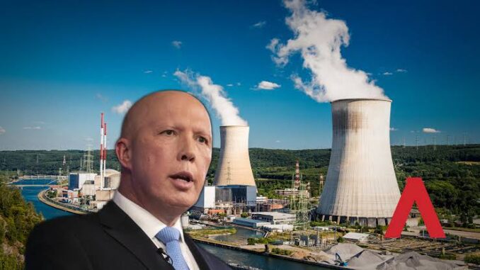 Man in suit with industrial plant background.
