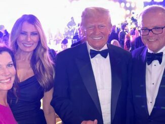 Four people smiling at formal event.