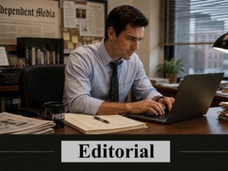 Journalist typing on laptop at editorial desk