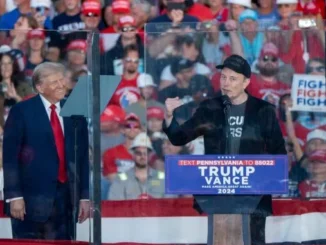 Two men speaking at a political rally.