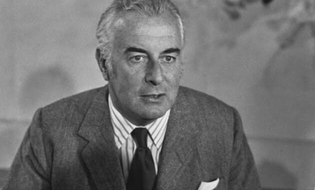 Man in suit and tie, black and white.