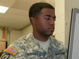 US Army soldier working at a computer.