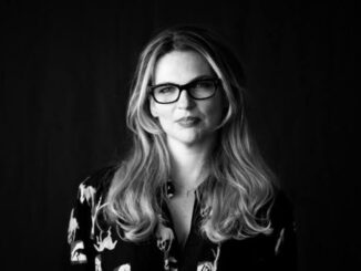 Woman with glasses in black and white.