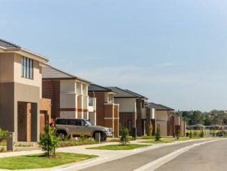 Suburban street with modern two-story houses.