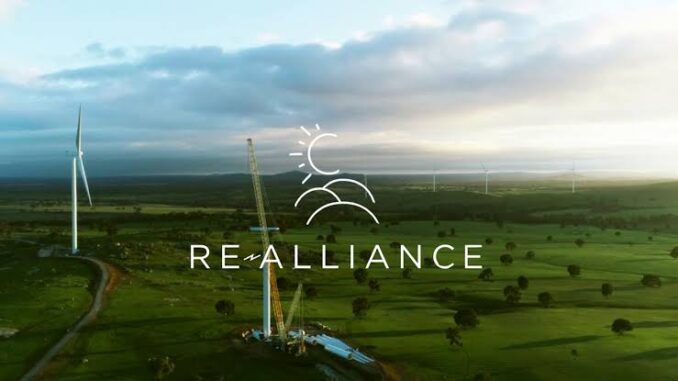 Wind farm landscape with RE-Alliance logo.