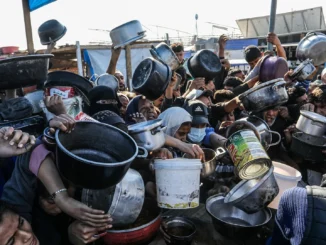 Crowd holding pots and pans in chaos.