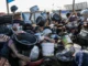 Crowd holding pots and pans in chaos.
