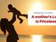 Mother lifting child at sunset, loving message.