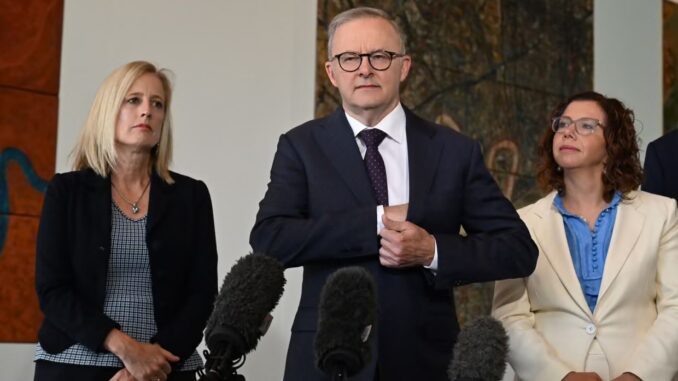 Three people speaking at a press conference. Three people speaking at a press conference.
