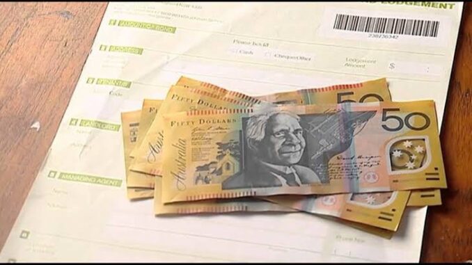 Australian dollars on top of a bill.