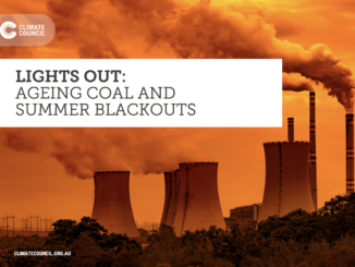 Coal plant with smoke and environmental message.