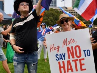 People holding "Say No to Hate" sign.