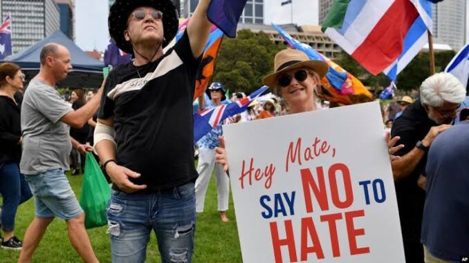 People holding "Say No to Hate" sign.
