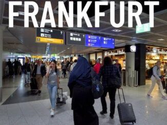 Frankfurt airport terminal with travelers walking.