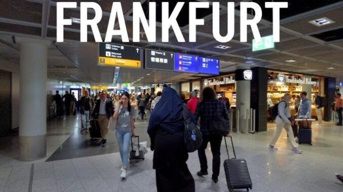 Frankfurt airport terminal with travelers walking. Frankfurt airport terminal with travelers walking.
