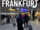 Frankfurt airport terminal with travelers walking.
