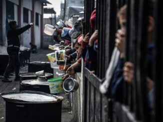 People holding containers for food distribution.
