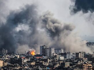 Cityscape with smoke rising from explosions.