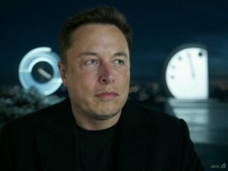 Man in black shirt with futuristic clocks.