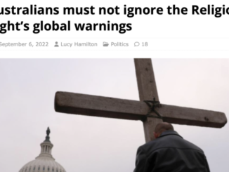 Person holding large cross near dome building.