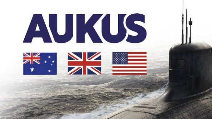 AUKUS logo with submarine and national flags.