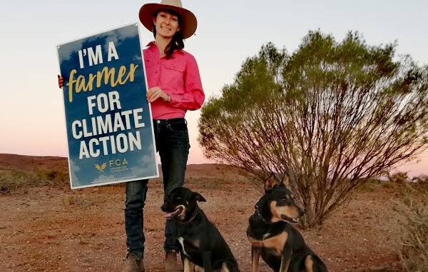 Farmer with climate action sign and dogs. Farmer with climate action sign and dogs.