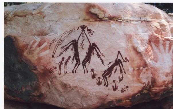 Ancient rock art depicting human figures and animals.