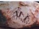 Ancient rock art depicting human figures and animals.