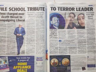 Open newspaper with articles and images displayed.