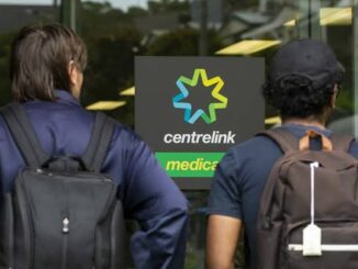 Two people outside Centrelink office entrance.