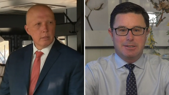 Two men in suits, one wearing glasses. Two men in suits, one wearing glasses.