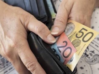 Hands holding wallet with Australian banknotes.