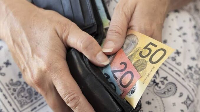 Hands holding wallet with Australian banknotes. Hands holding wallet with Australian banknotes.