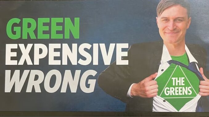 Man opening shirt revealing The Greens logo. Man opening shirt revealing The Greens logo.