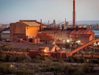 Industrial factory complex at sunset.