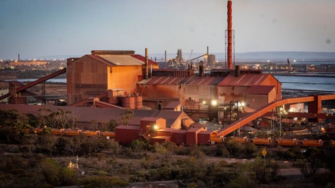 Industrial factory complex at sunset.