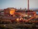 Industrial factory complex at sunset.