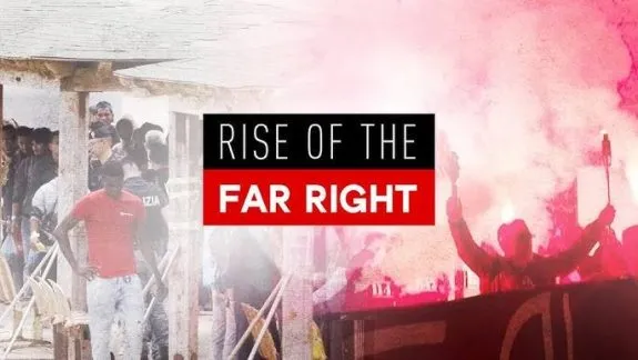 Red smoke demonstration contrasted with migrants