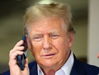 Man talking on phone, wearing suit jacket.