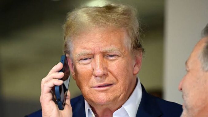 Man talking on phone, wearing suit jacket.