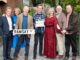 Group of people standing with Ramsay Street sign.