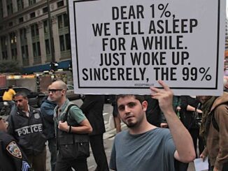 Protester holding sign in city street.
