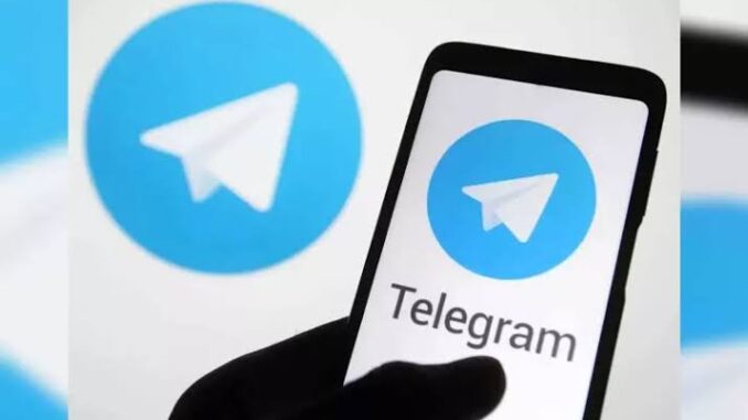 Telegram app logo on phone and screen. Telegram app logo on phone and screen.