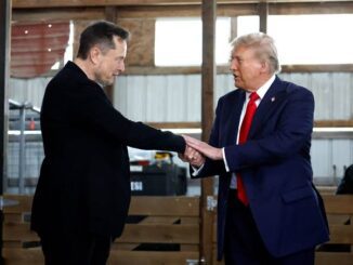 Two men shaking hands indoors.