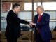 Two men shaking hands indoors.