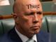 Bald man with "Thug" on forehead.