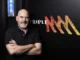Man standing next to Triple M logo.